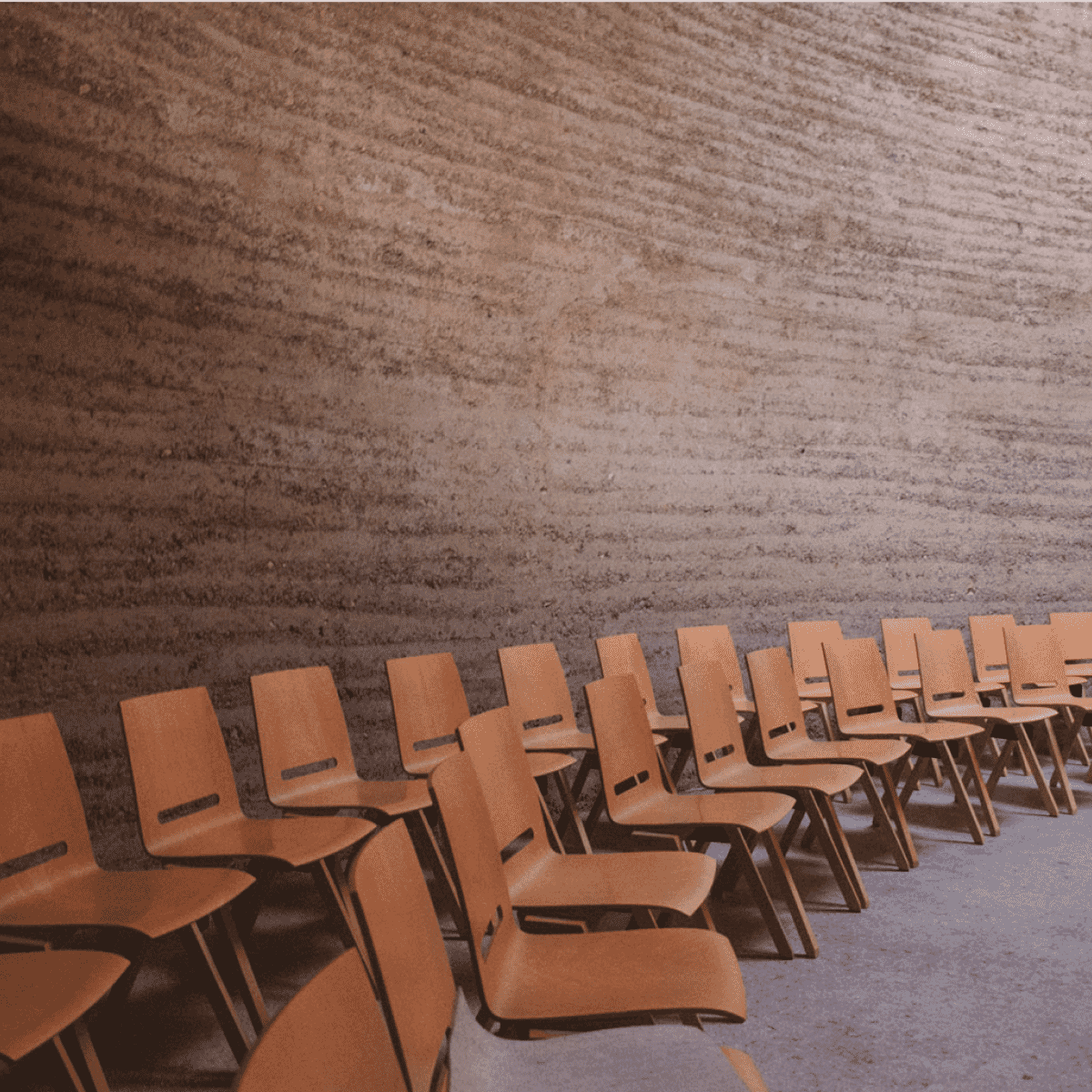 two lines of wooden chairs in classroom setting