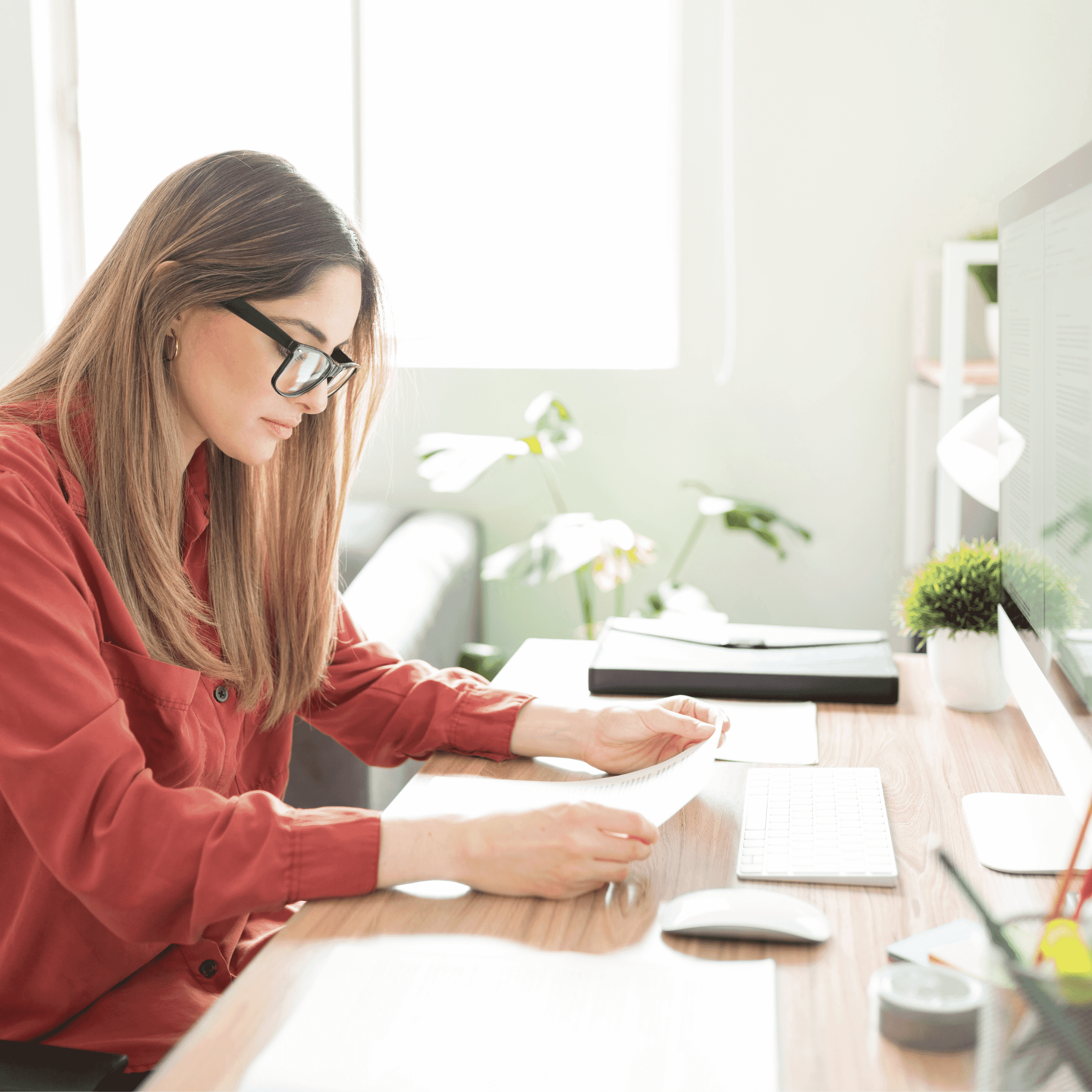 woman reading paper at desk