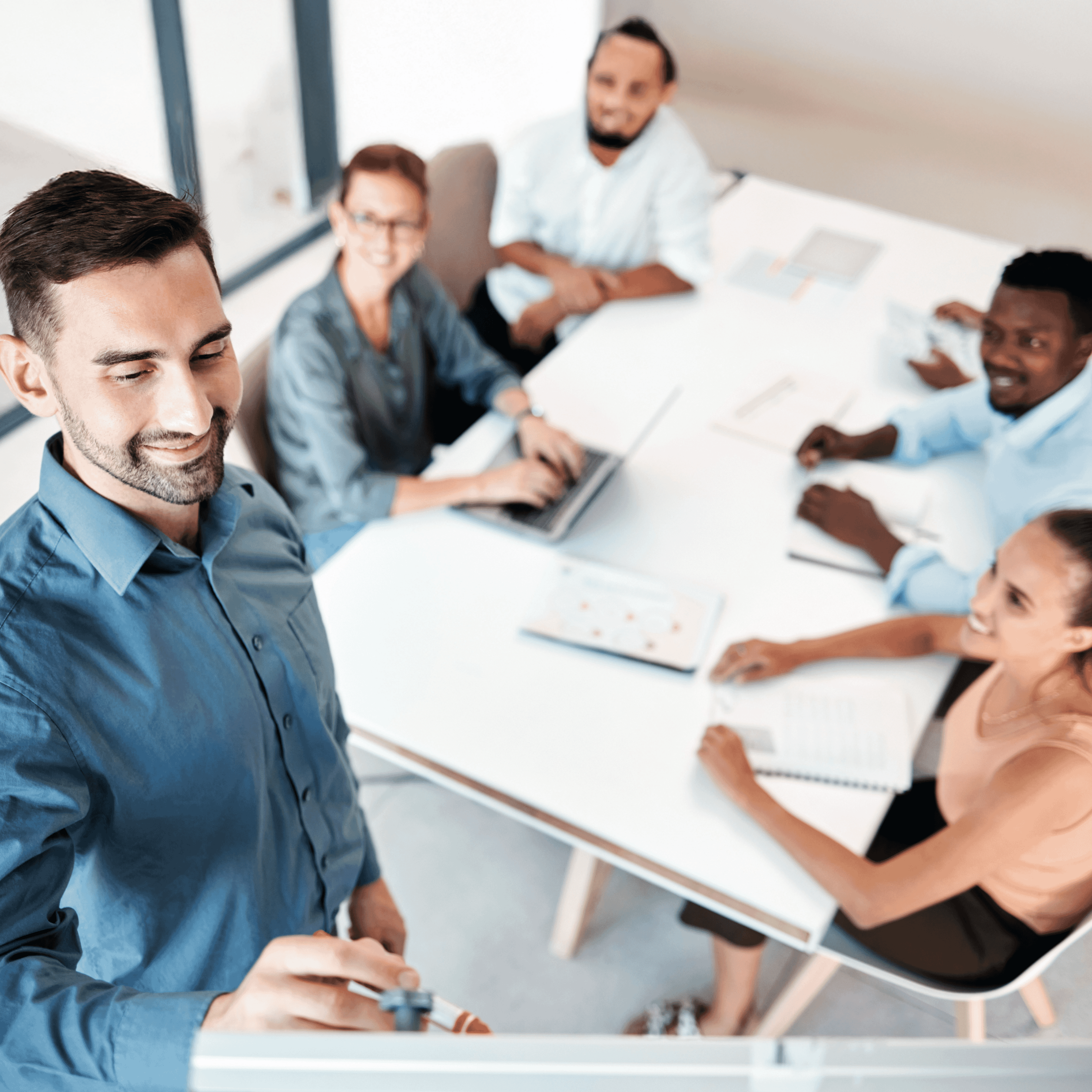 photo of someone presenting to a group of 4 colleagues around a table