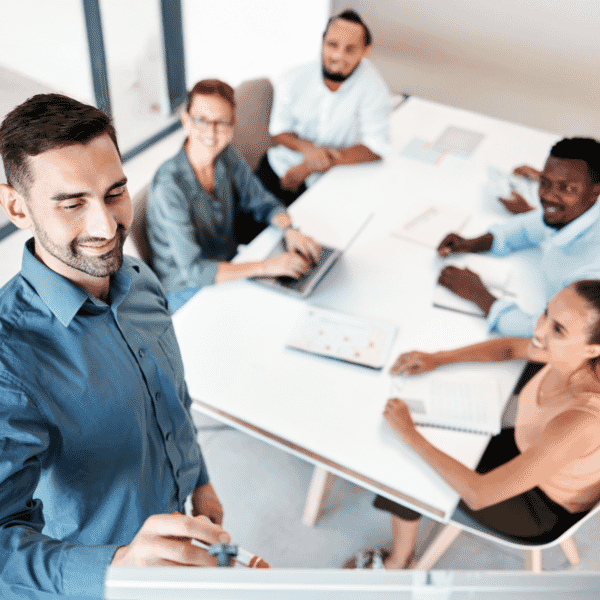 photo of someone presenting to a group of 4 colleagues around a table