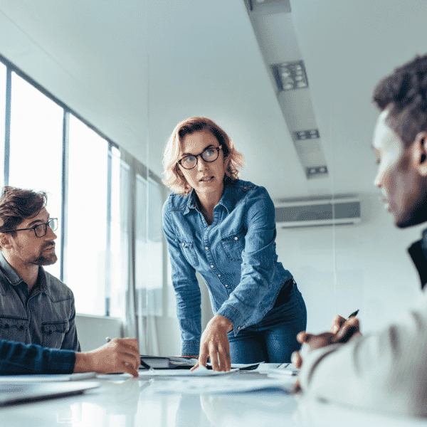 A group of professionals discussing paper on a table