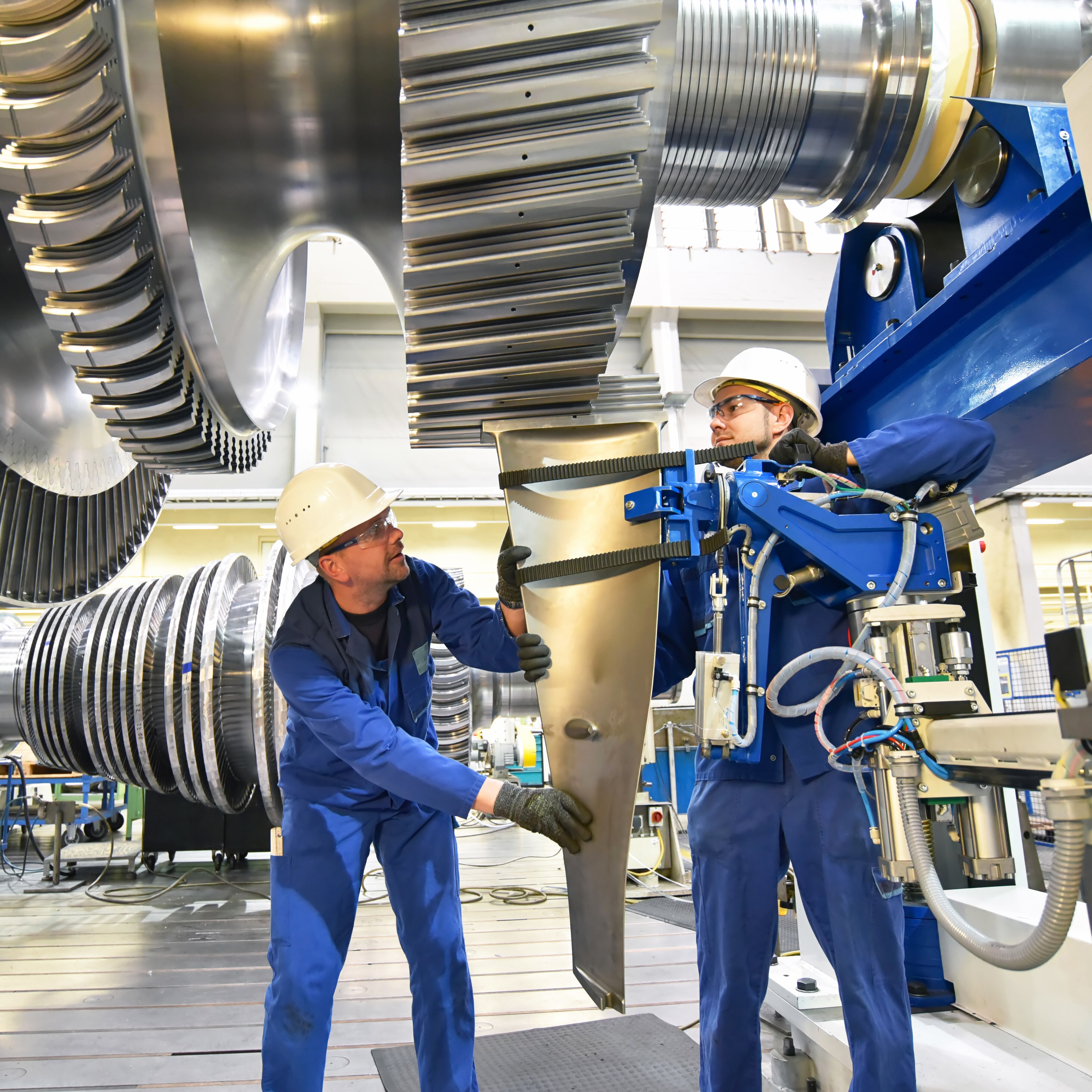 Two men on a factory floor working together.