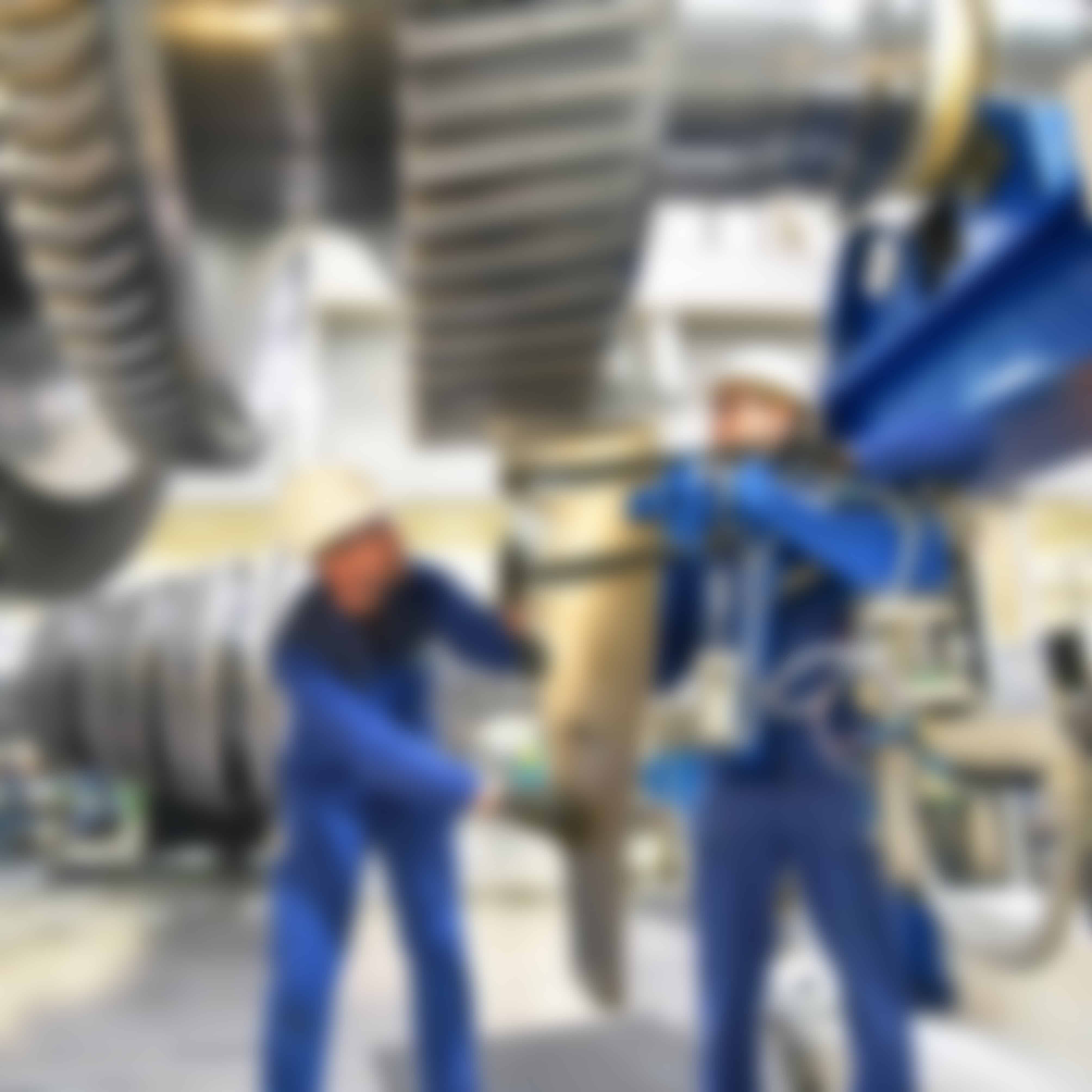 Two men on a factory floor working together.