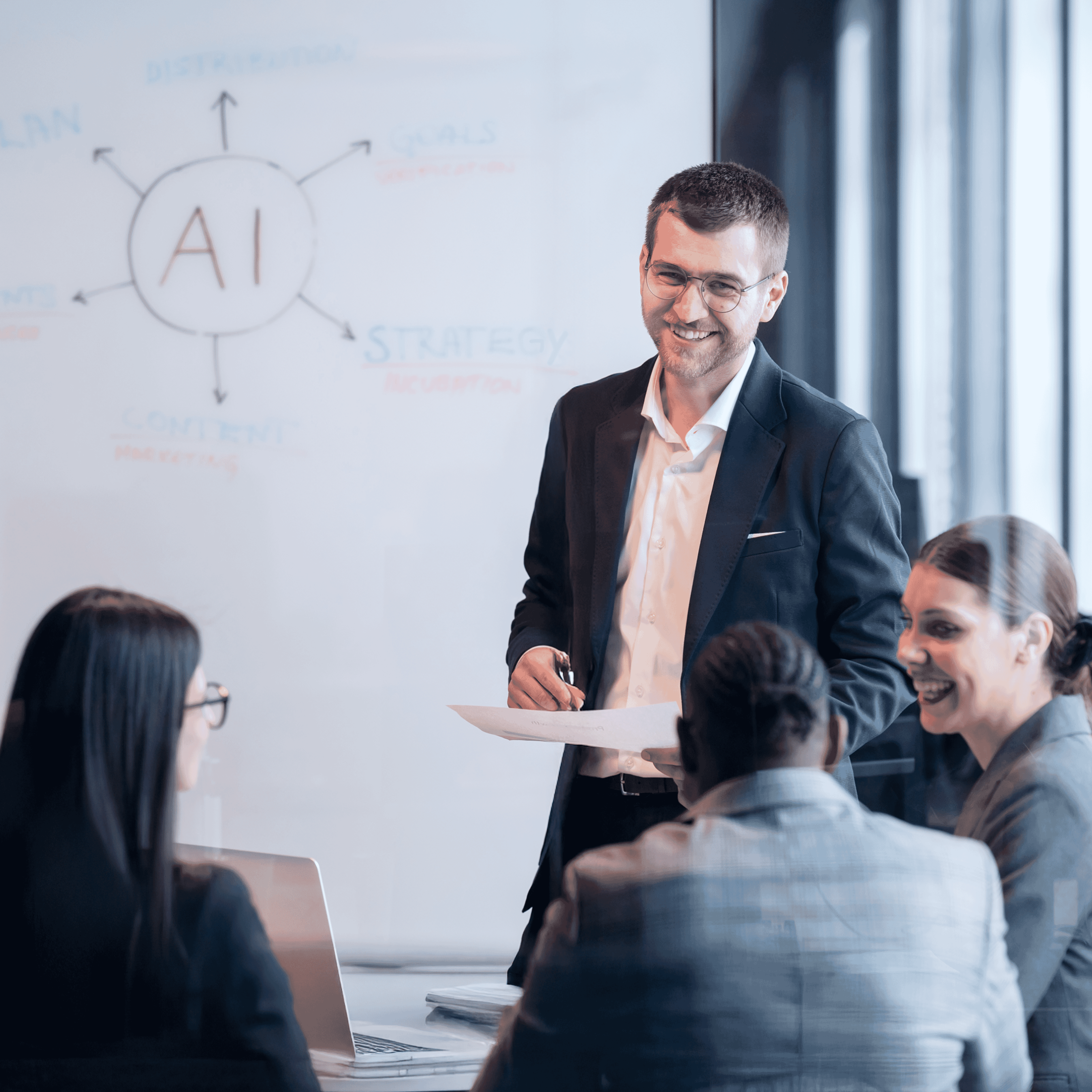 usiness team in a meeting discussing AI strategy with a whiteboard diagram in the background.