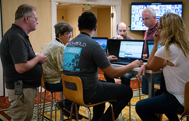 Photo of people working in the MadWorld 2018 lounge