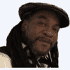 headshot of Dipo Ajose Coker in a hat