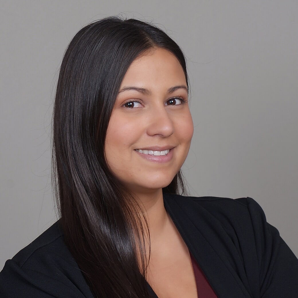 photo of woman in black blazer with arms crossed in front of her