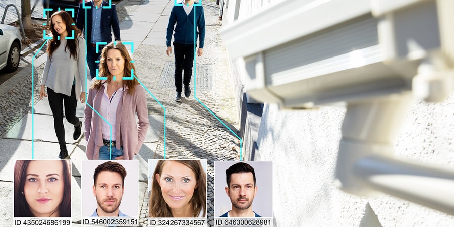 Photo of a person walking and being scanned by a face tracking camera