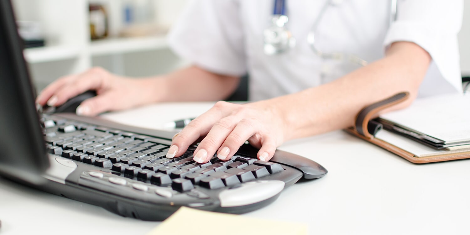 Medical staff member typing on keyboard