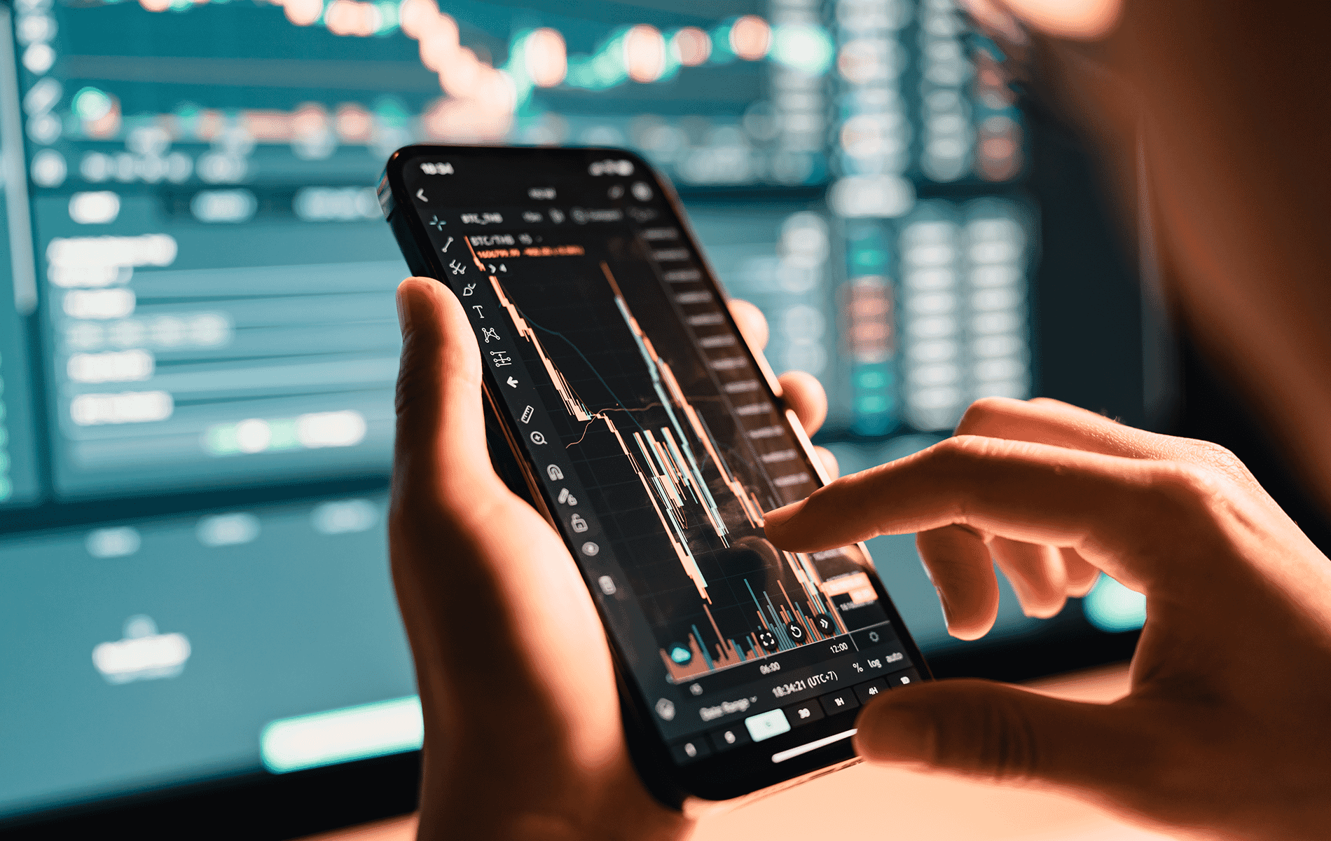 Image of Financial Charts on a phone and computer screen