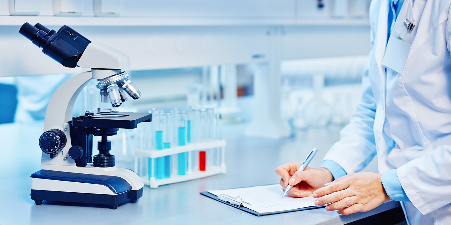 Photo of someone taking notes in a lab