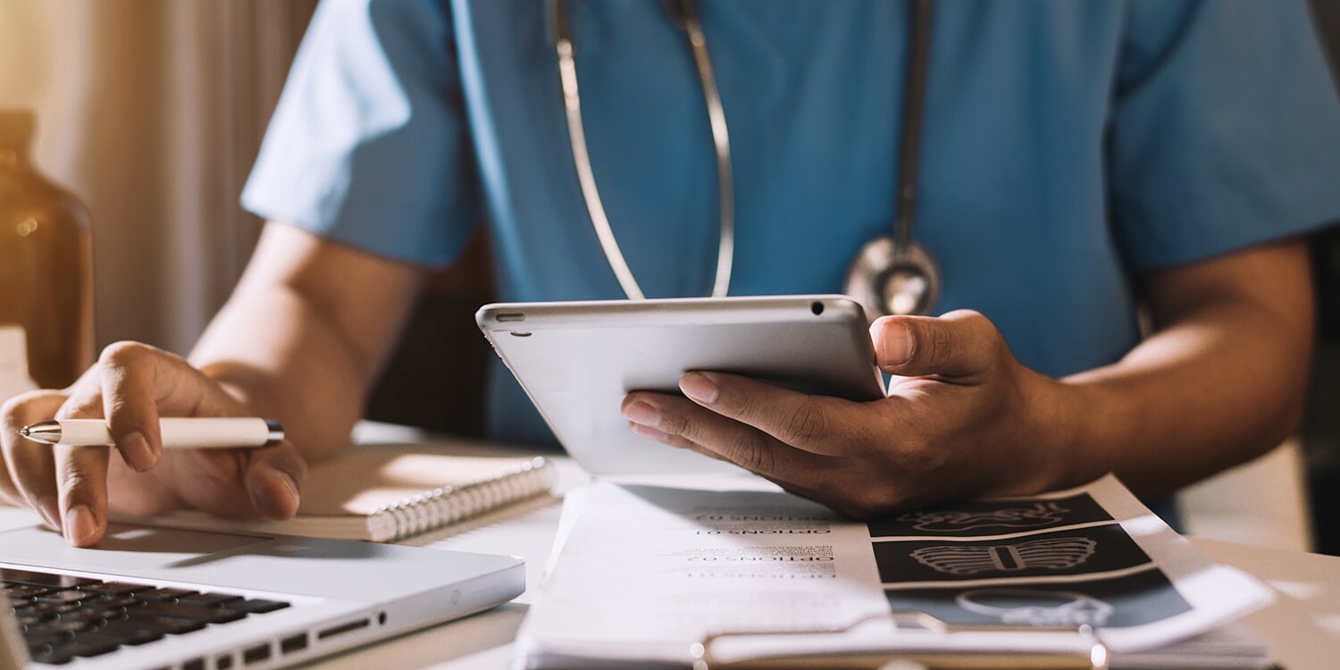 Medical staff member using tablet