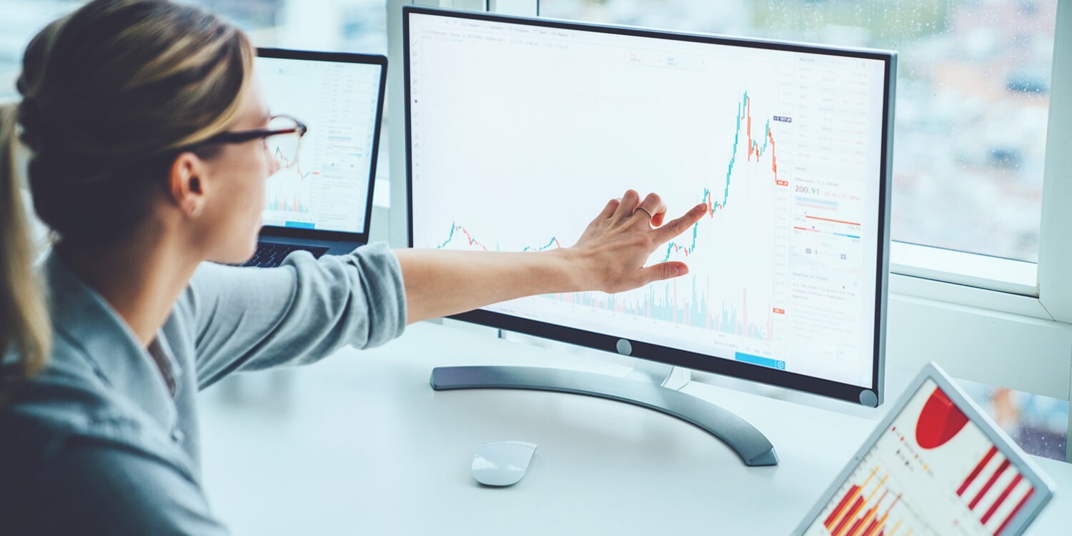 Woman pointing at computer monitor