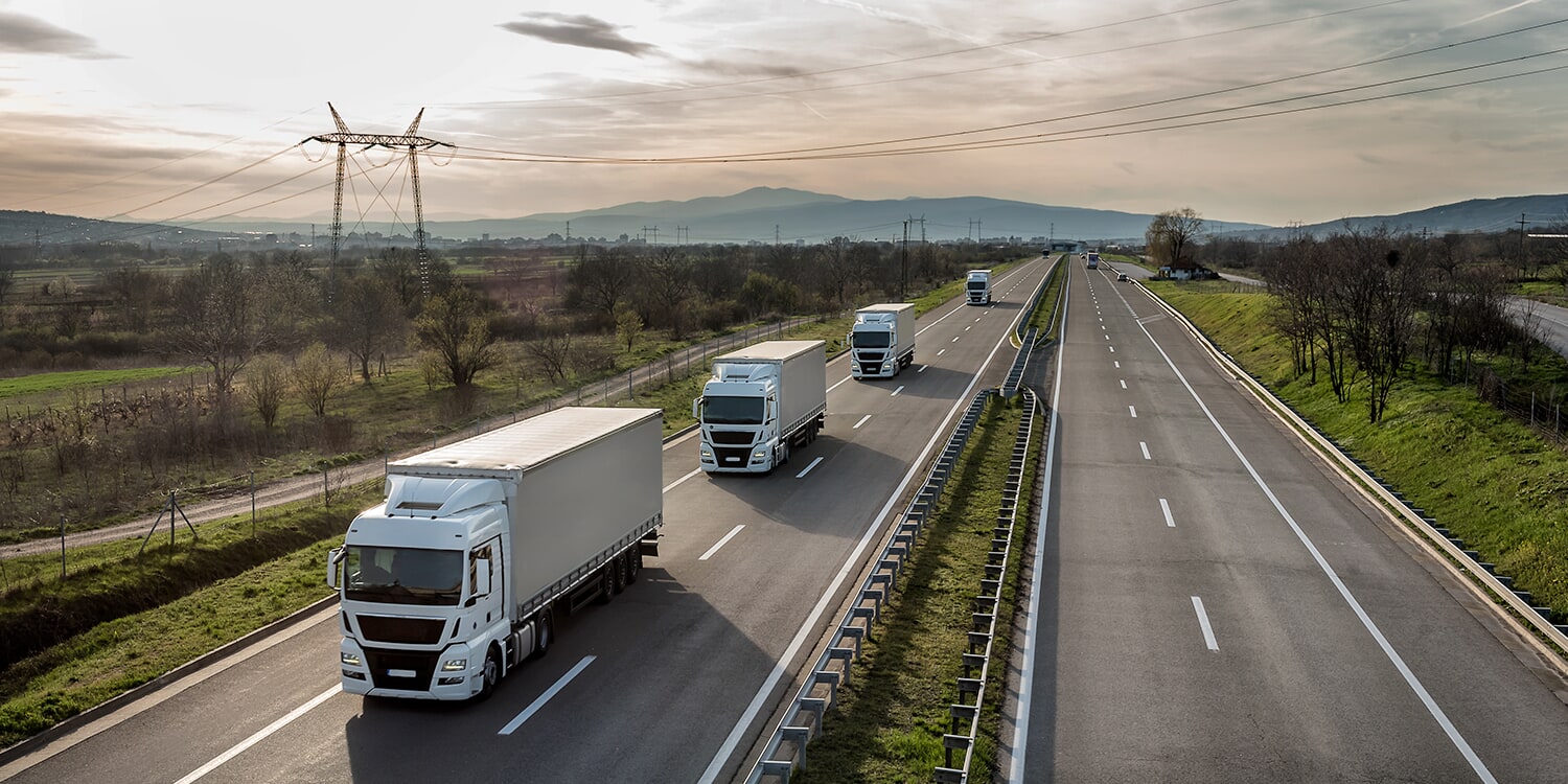 Photo of multiple semi trucks on the road
