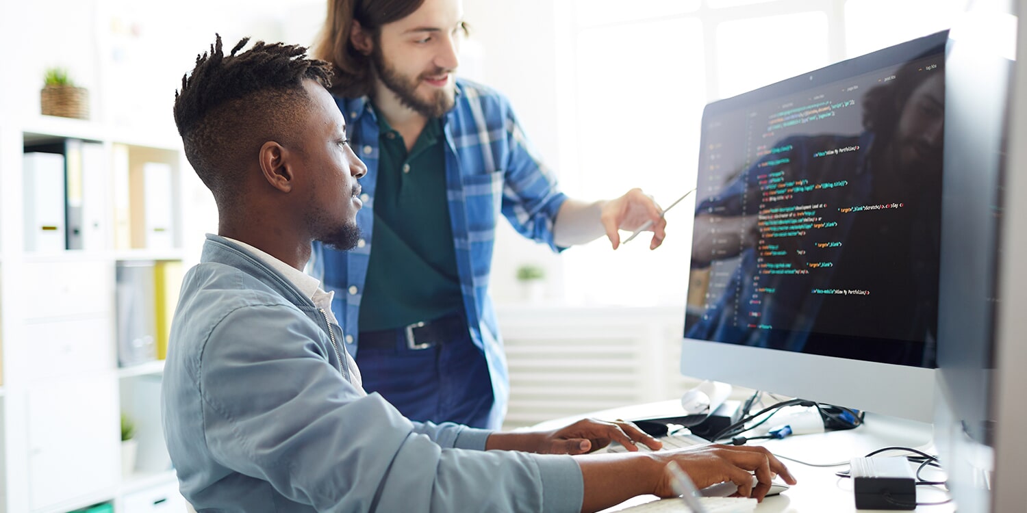 Photo of someone pointing at a computer screen