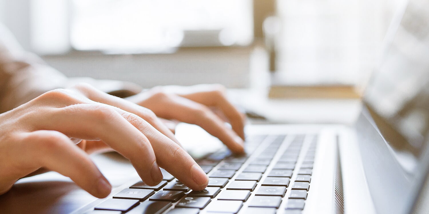 Photo of someone pointing at a spreadsheet